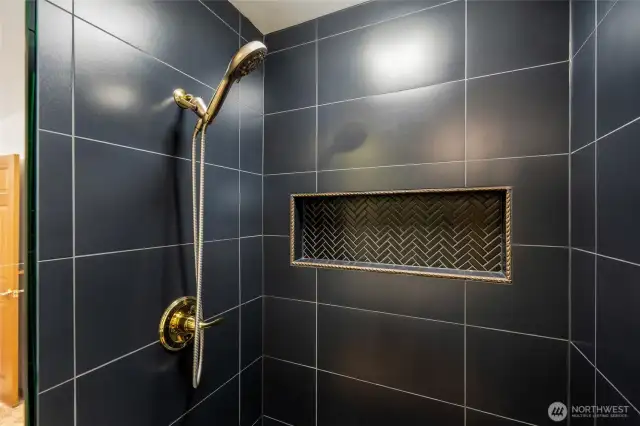 Walk in shower with modern tile and finishes.