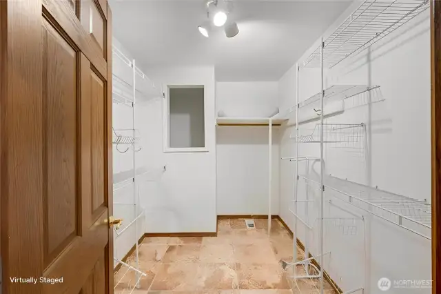 Large walk in closet with extra storage space.