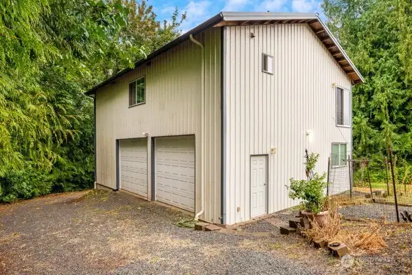 Detached 2,400 sqft, two story shop with wrap around driveway that leads to second property access.