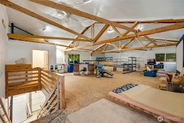 1,200 sqft upper level of the shop with high ceilings, sink and counter space, and 3/4 bathroom perfect for a home business or potential apartment.