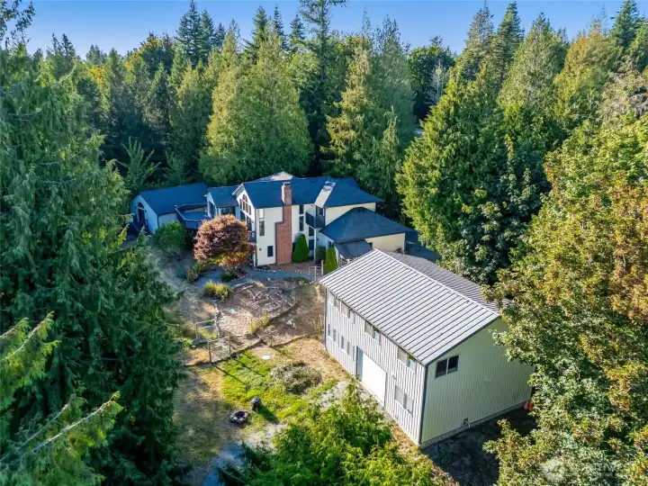 View of the home and shop. The driveway also wraps through the property for easy in and out access.