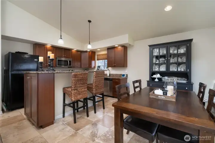 Kitchen with tall eating bar and adjoining dining area