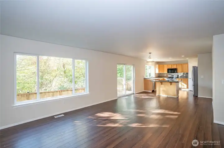 The expansive picture window captures serene backyard and greenbelt views, seamlessly bringing the outdoors inside.
