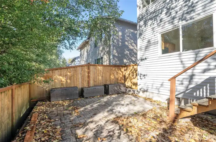Stamped concrete patio located just below the deck.