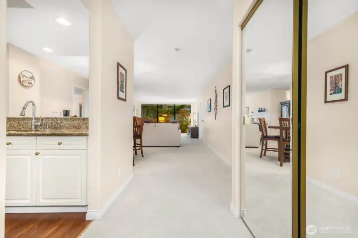 Entry corridor showcasing mirrored closet doors and continuous natural light.