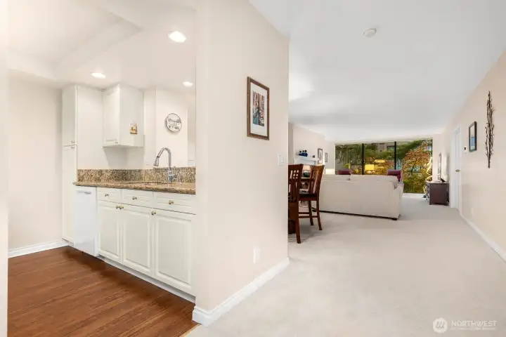 Transition from kitchen to living area, emphasizing sightlines and treetop views.
