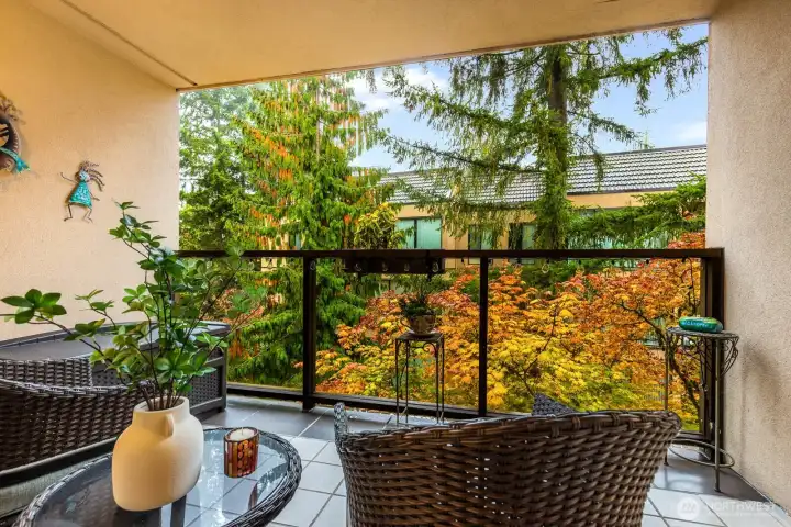 Relax outdoors year-round on the private, tiled deck overlooking lush foliage.