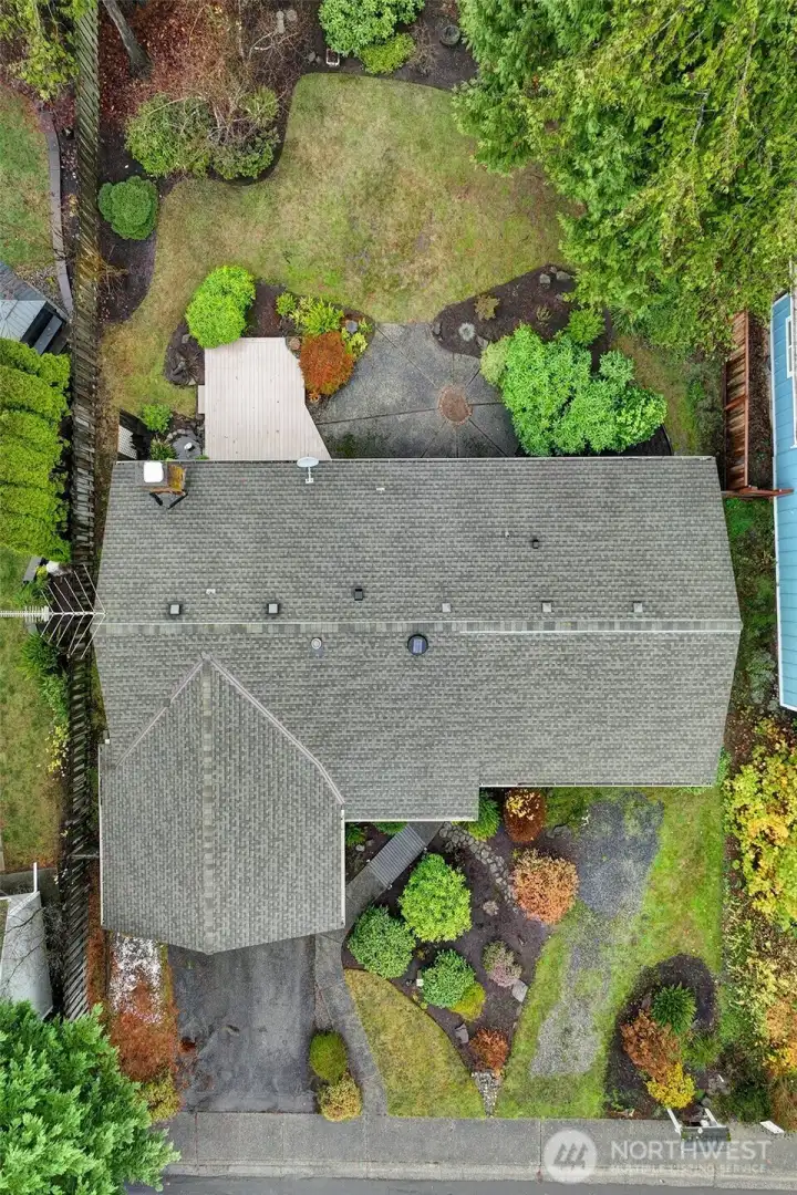 The home is surrounded by beautiful garden spaces and a storage/gardening shed for additional storage.