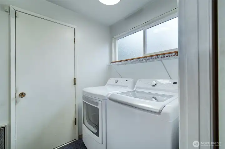 Washer and dryer have been used fewer than 10 times since purchased new. The door to the left opens to the 2 car garage with workspace.