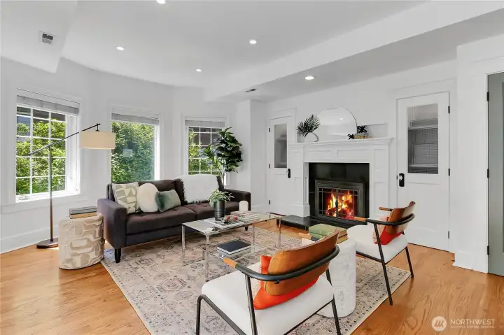 Cozy main living room anchored by a fireplace that serves as the warm focal point of the space.