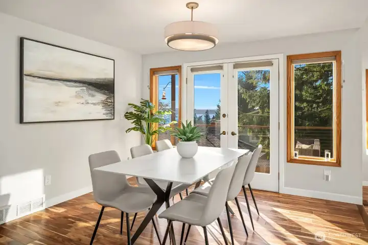The dining room is bathed in golden light through the french doors.
