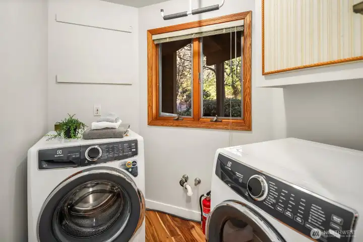 Laundry room with storage is easily accessible on the main level off the family room.