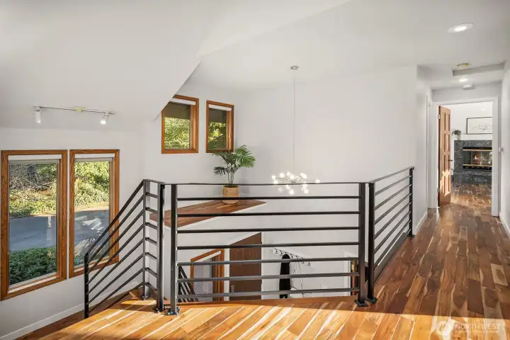 The upstairs landing and hall shows the beautiful acacia wood floors.