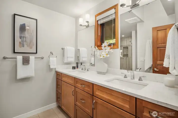 The roomy primary ensuite bath has double vanities and a spacious shower.