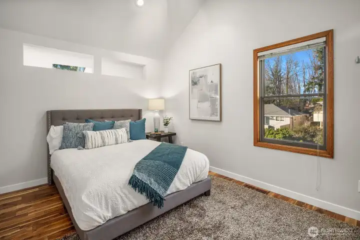 The third bedroom with vaulted ceilings and an extra large closet on the opposite wall is located on the opposite side of the primary suite upstairs, allowing privacy and separation.