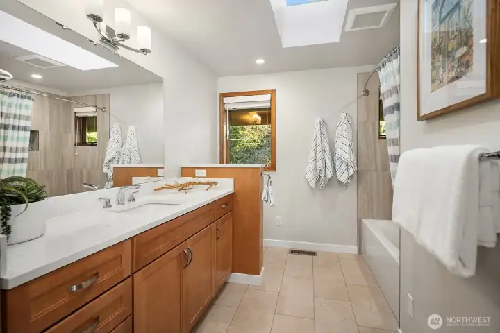 This upper level spacious full bath is off the hall and shared by the second and third bedroom. Spacious deep soaking tub and skylight adds luxury.