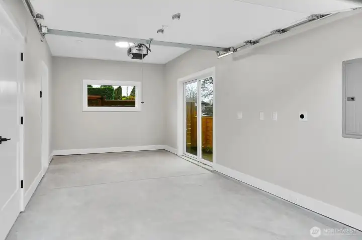 Finished garage with sliding door to fenced side yard