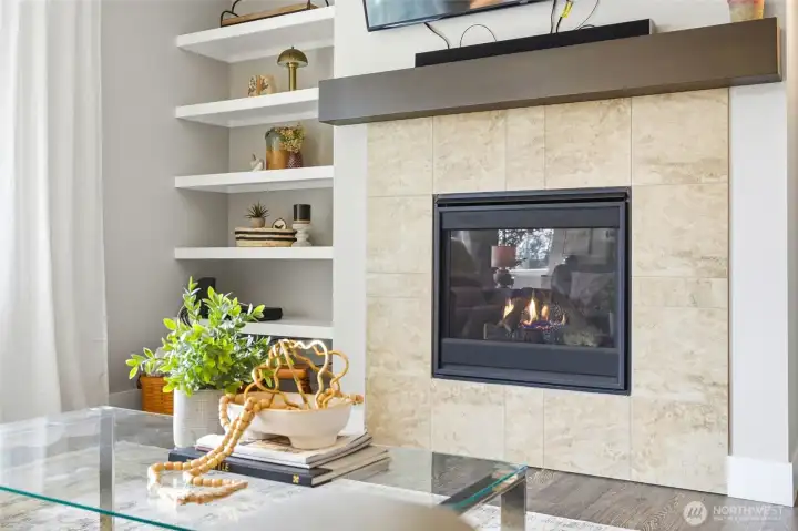 warm and inviting gas fireplace with nice built-in shelving
