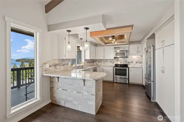 Stainless steel appliances in updated kitchen.