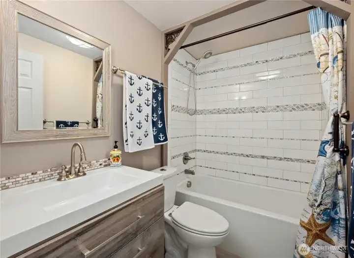 Guest bathroom with tub/shower combination.