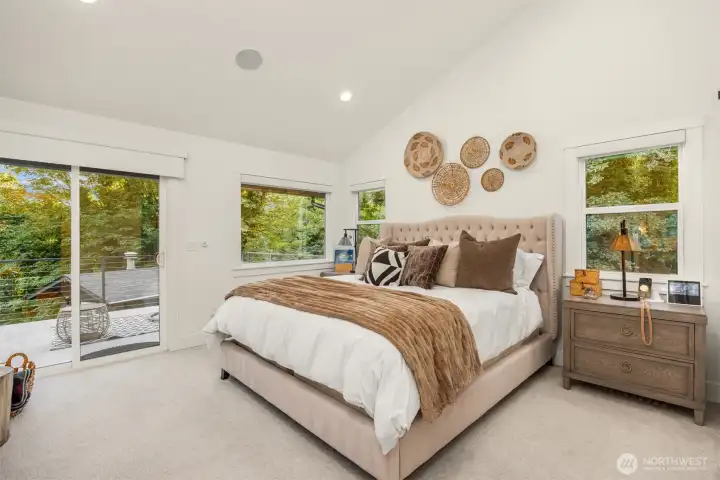 Primary suite with private balcony looking over property