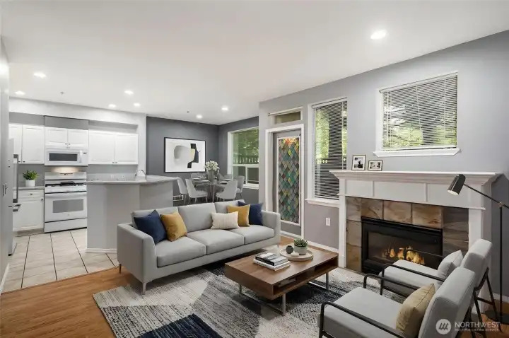 Great Room with laminate hardwood and tile flooring and chef's kitchen with gas cooking and pantry shelves-Virtually staged.
