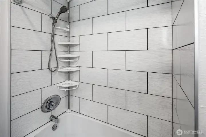 New tile surround in Primary Bathroom.
