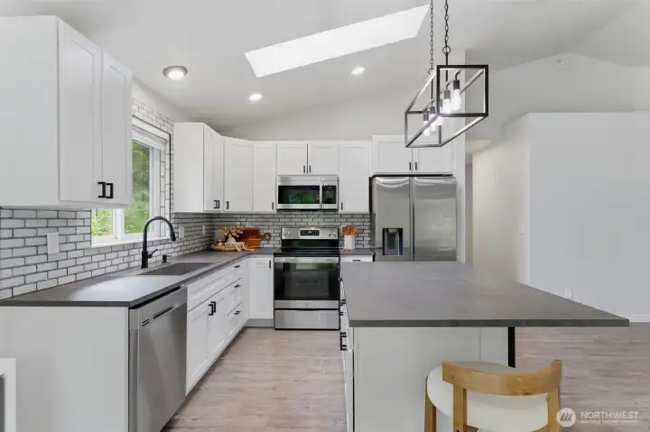 Equipped with matching stainless steel appliances that stay with the home, making this stunning kitchen completely move-in ready.