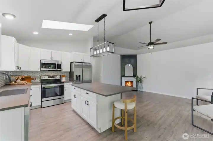 Notice the stunning new LVP flooring running beneath the crisp cabinetry, adding warmth and durability to this highly functional, stylish kitchen.