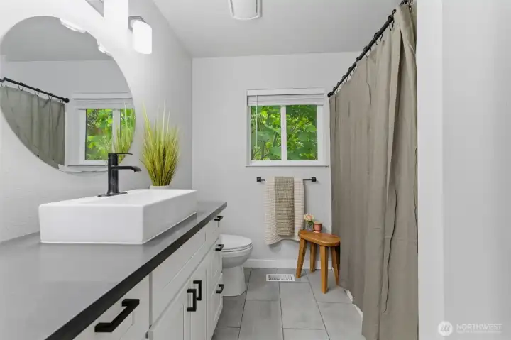Beautifully updated. Stylish hardware and modern fixtures elevate the dual vanities, matching the sleek look found throughout the rest of the home.
