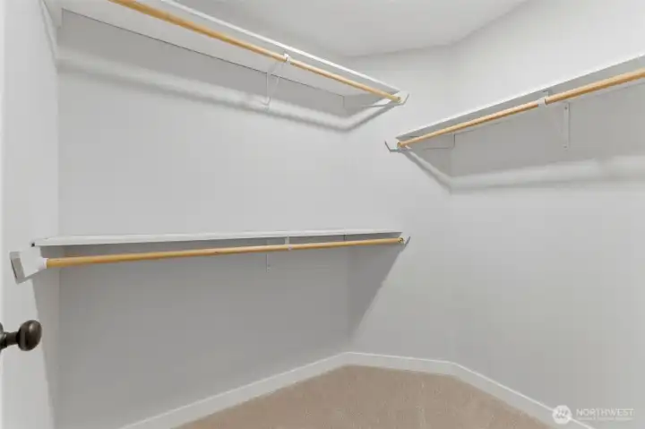 Storage dreams do come true! This deep, spacious walk-in closet off the primary suite offers plenty of hanging space and shelving for all your wardrobe needs.