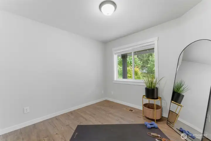 Ideal for remote work or guests. The large window fills the room with natural light and looks out onto the peaceful, private surroundings.