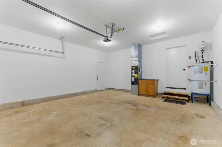 nother view of the generous garage space. Pristine floors, clear walls, and a new-home feel make this space highly versatile for hobbies or storage.
