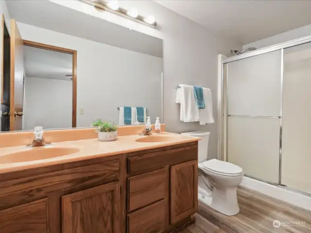 Primary attached bathroom features double sink and walk-in shower.