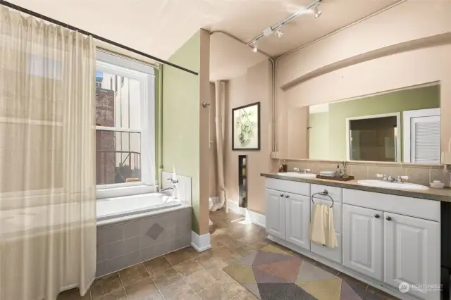 The bathroom features a jetted tub and a step-in steam shower. The dual vanity is a ply.