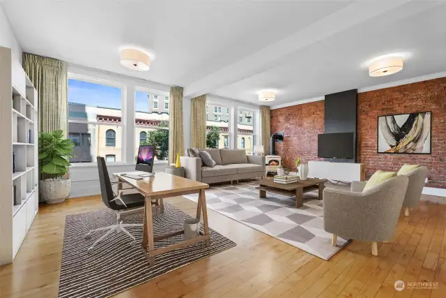 The living room is shown here with a home office setting. This space is surprisingly abundant!