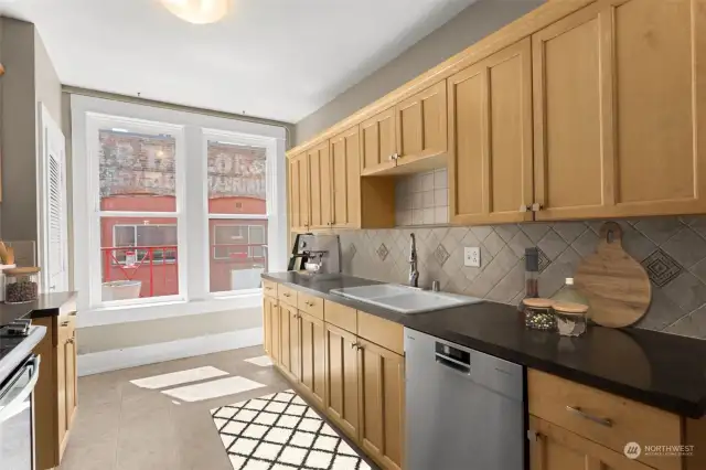 The red railings are on the fire escape, seen from the kitchen window. If you are adventurous, climb through the kitchen or bathroom windows to bask in the sunshine.