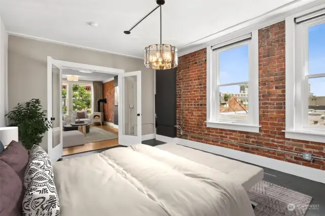 Now you are in the bedroom looking into the living room. The original brick walls lend this home lots of vintage charm.