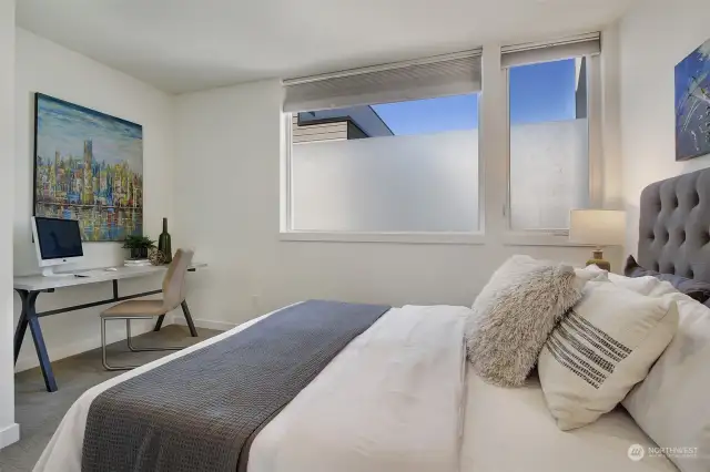 Upstairs primary bedroom with space for a home desk/office.