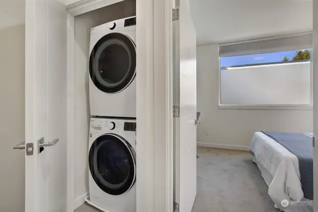 Upstairs washer/dryer stack outside primary bedroom.