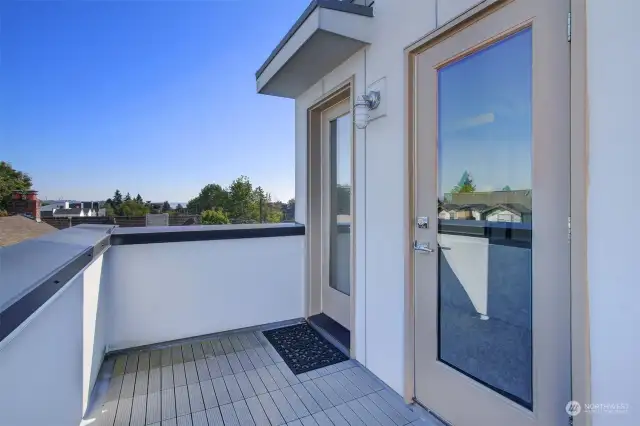 The top floor leads out to a rooftop deck with storage closet.