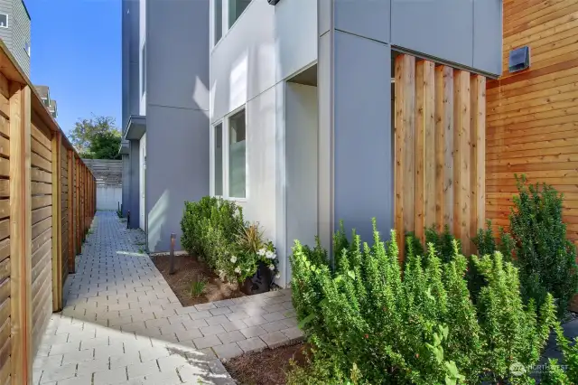 The paver pathway leads to a covered + private entry.