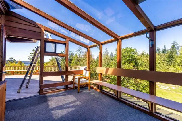 Sunroom off of Living Room opens to Large Entertaining Front Deck