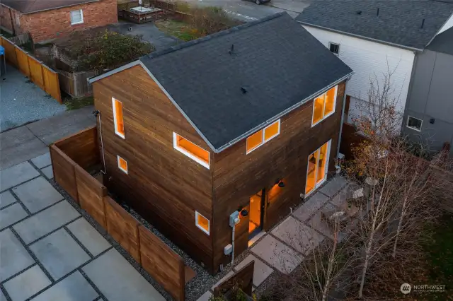 Exceptional architectural elements abound in this Hillman City home featuring reclaimed building materials and curated technology. The exterior reflects a modern farmhouse aesthetic with its wood siding and other distinct fixtures.