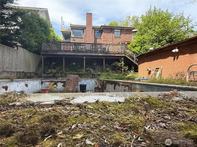 View of old swimming pool from alley.