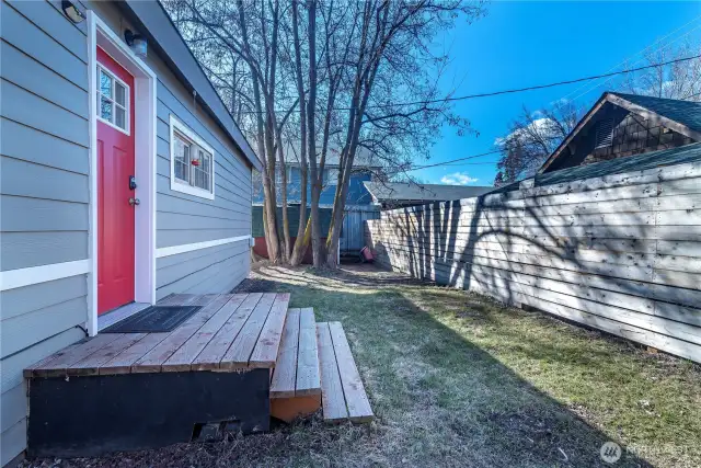 Nice yard with a privacy fence and trees.