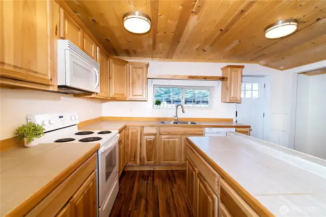 Abundance of pine cabinets with plenty of storage in the kitchen.