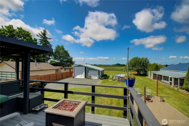 View from deck off kitchen looking at second garage and shop (left) chicken coop (right) above ground pool just waiting to filled for summer fun.