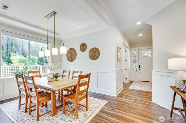 The dining room boasts space for a side table / buffet. Beautiful lighting throughout the home.