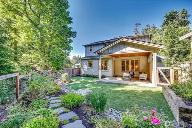 Gorgeous fully-fenced yard with native plants and turf for easy care! Veggie plot! Gas BBQ hook-up in covered back patio.